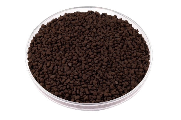 A close-up, top-down view of CARULITE® 200 catalyst, which consists of small, dark brown, granular pellets, displayed in a clear glass petri dish against a white background.