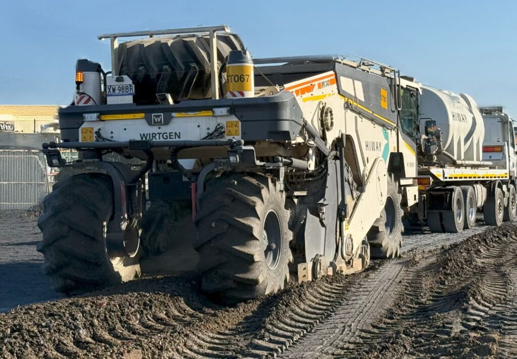 A road stabilizer mixing amendment into soil in place.