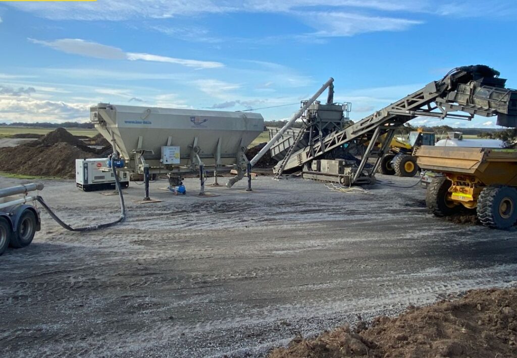 A pug mill blending RemBind Sorbents through soil at a controlled ratio.