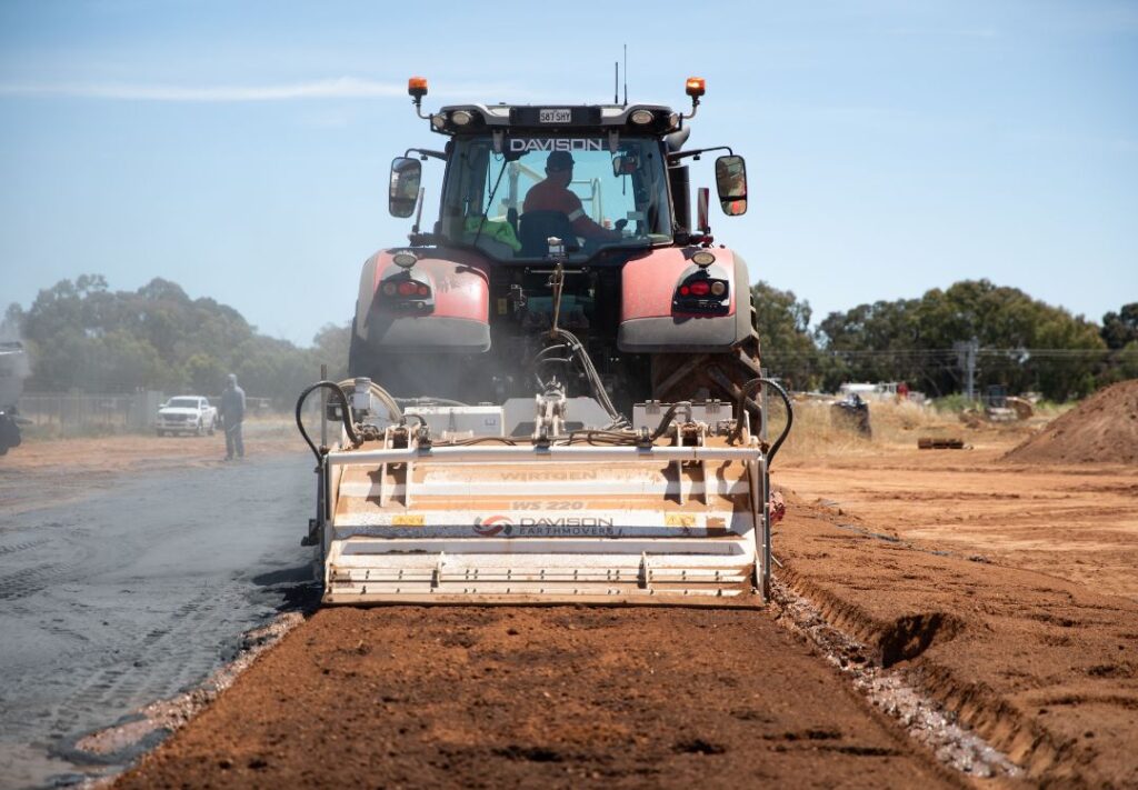 A tractor-towed stabilizer incorporating amendment across a treatment area.