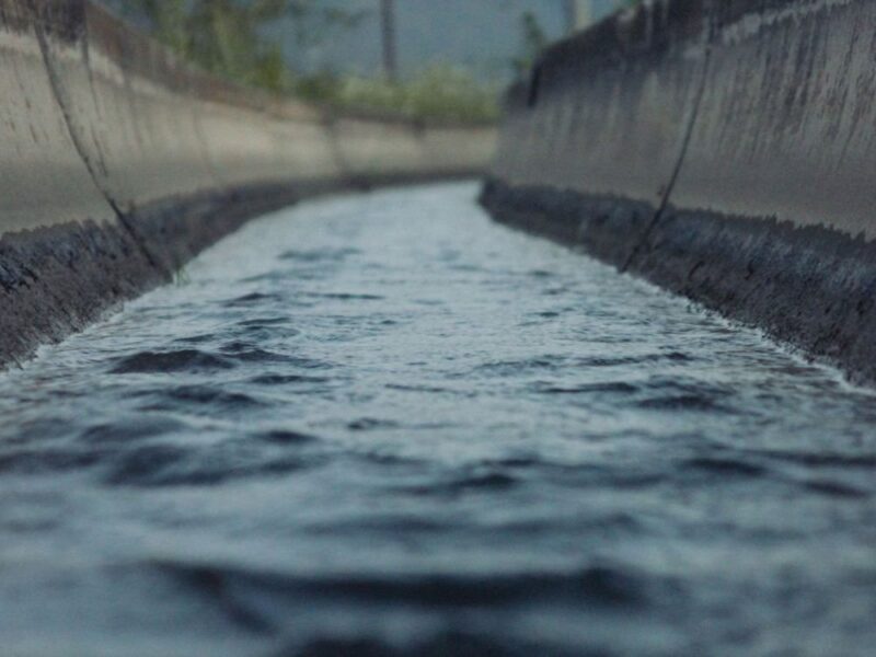 A concrete stormwater channel carrying runoff.