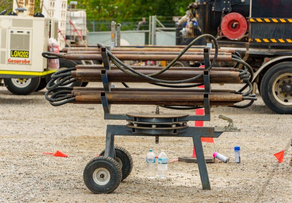Direct-push injection rods racked on a trailer at a groundwater treatment site.