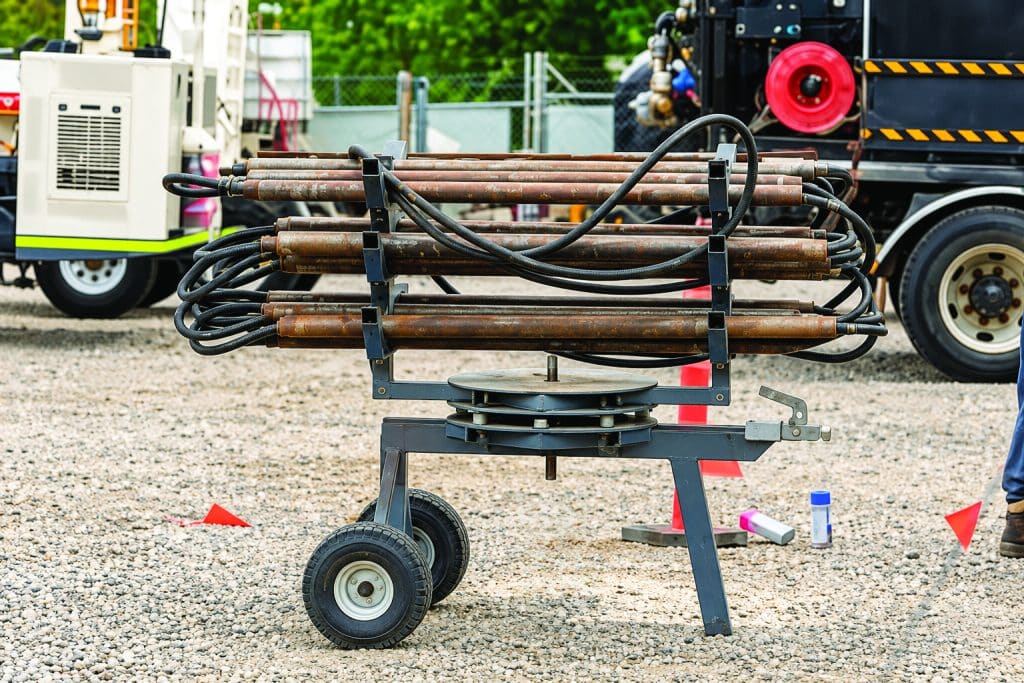 Direct-push injection rods racked on a trailer at a groundwater treatment site.