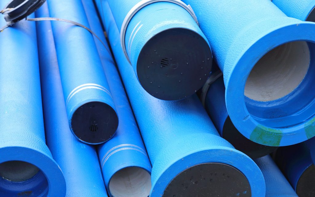 various sized blue pipes stacked